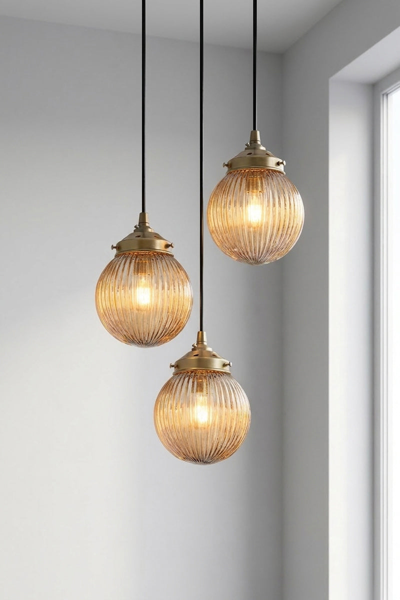 3 drop multi pendent with dark amber reeded glass ball shades. 