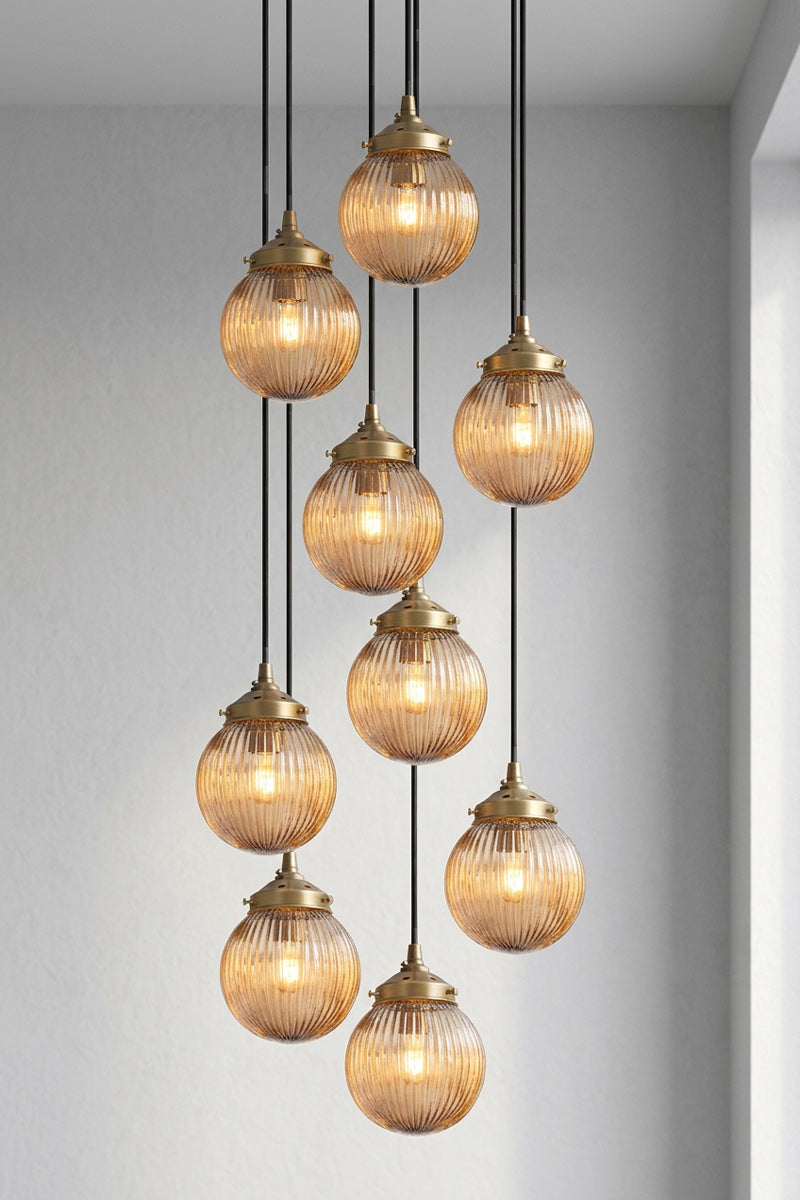 9 drop multi pendent with dark amber reeded glass ball shades. 