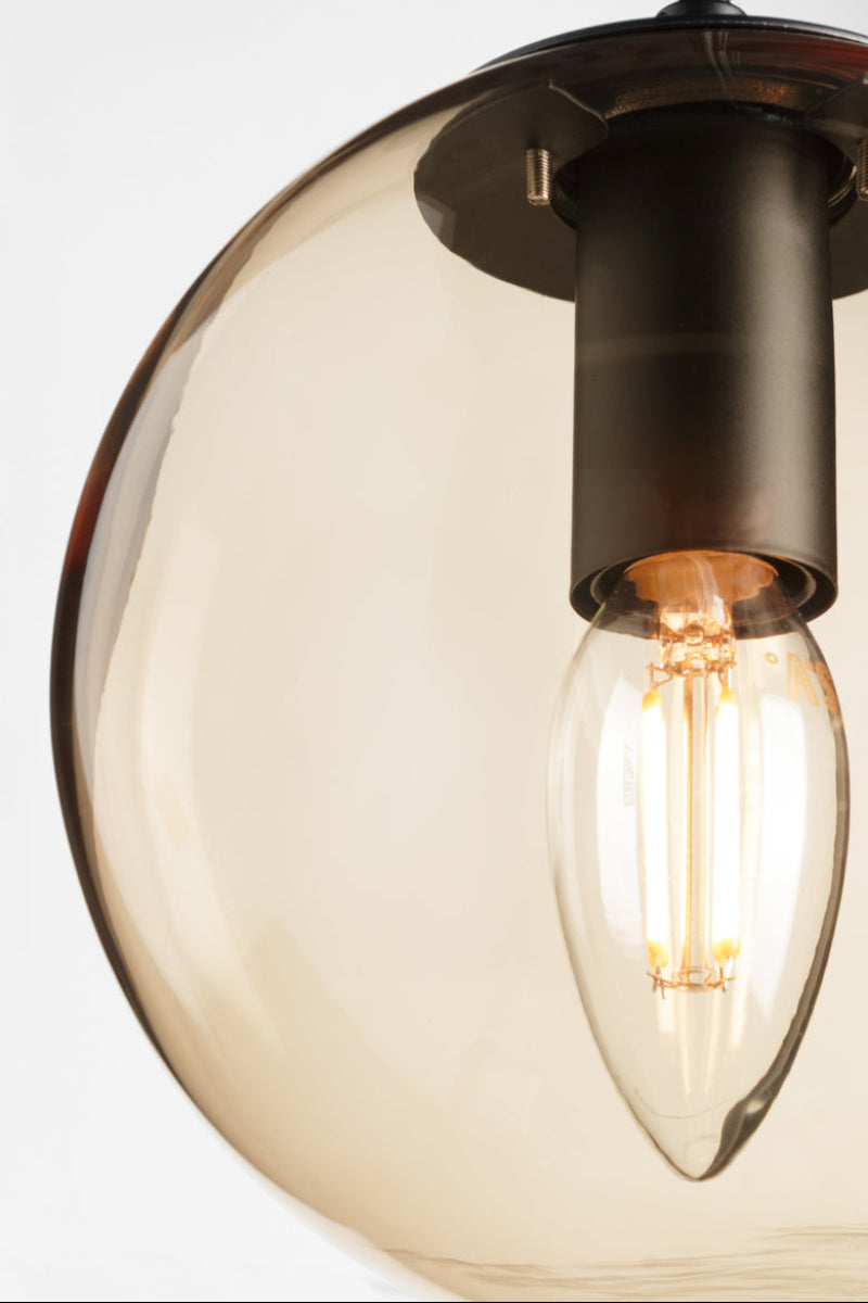 Close up of he amber finish glass orb shade.