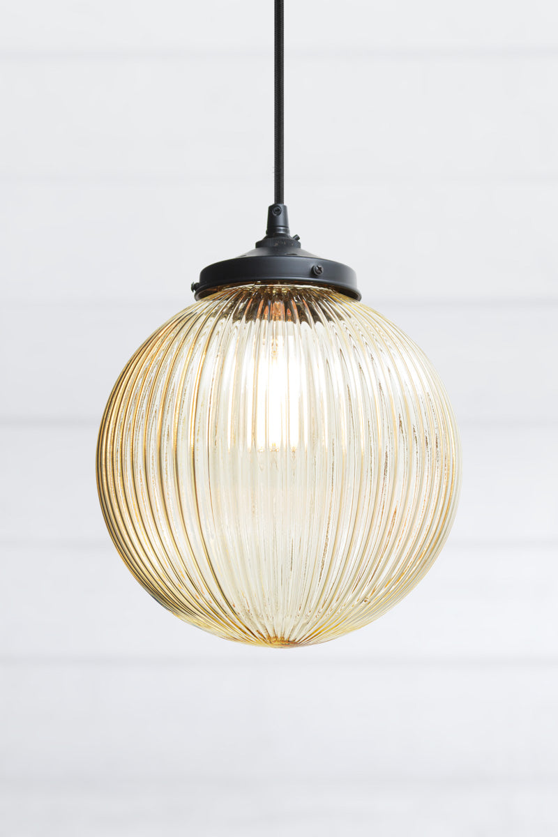 Dakota Reeded Glass Pendant Light medium amber glass on black cord