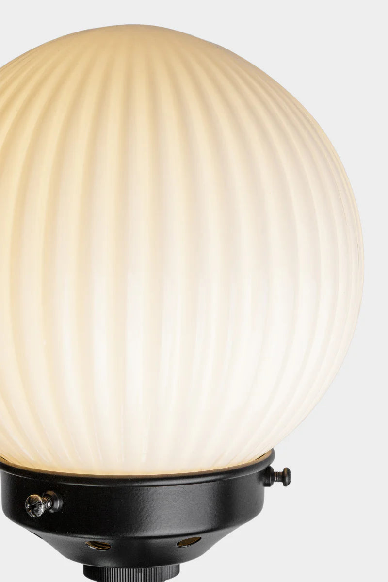 Close up of the Black five lamp linear chandelier with opal reeded glass ball shades. 