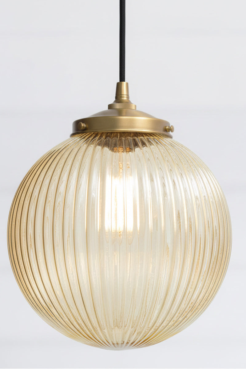 Amber reeded glass on pendant light with glass shade and gold/brass fitting with black cord 