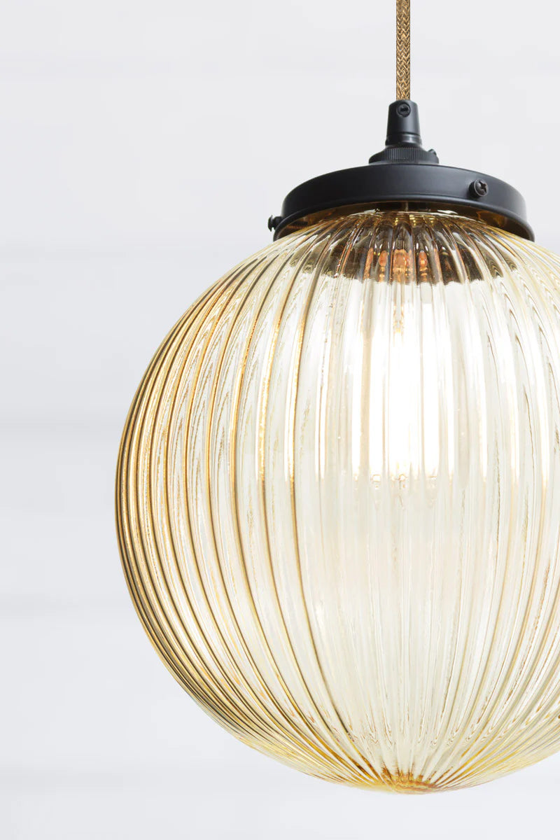 close up of Dakota Reeded Glass Pendant Light medium amber glass on jute cord