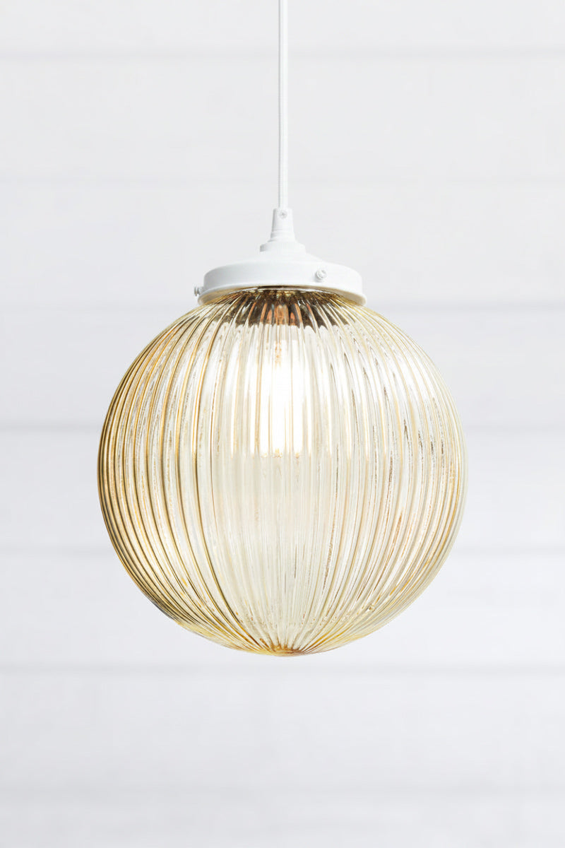 Amber reeded glass on pendant light with glass shade and white fitting with white cord 