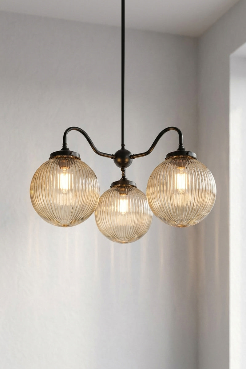 3 arm in black and 3 medium reeded glass shades in amber 