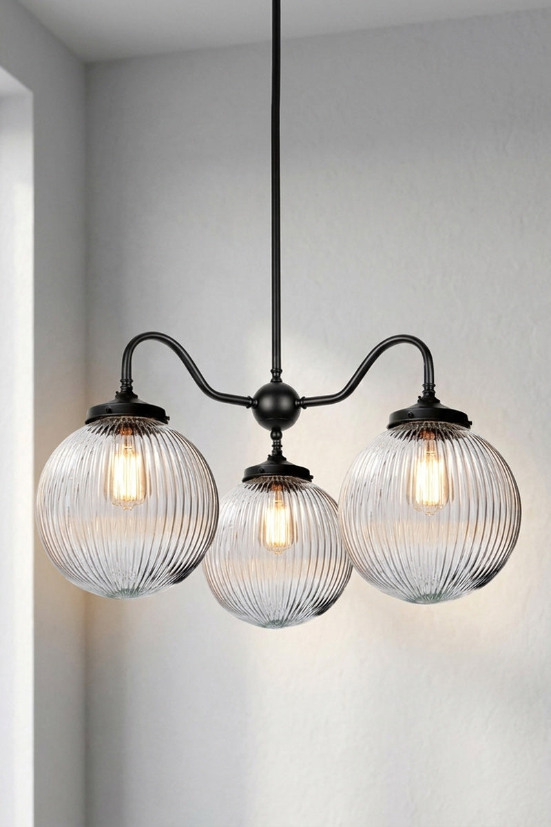 3 arm in black and 3 medium reeded glass shades in clear.