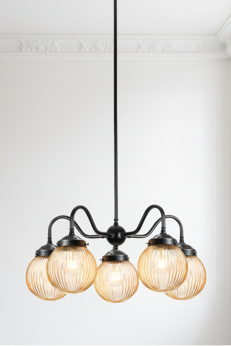 5 arm chandelier with gooseneck style arms in black with amber reeded glass ball shades. 
