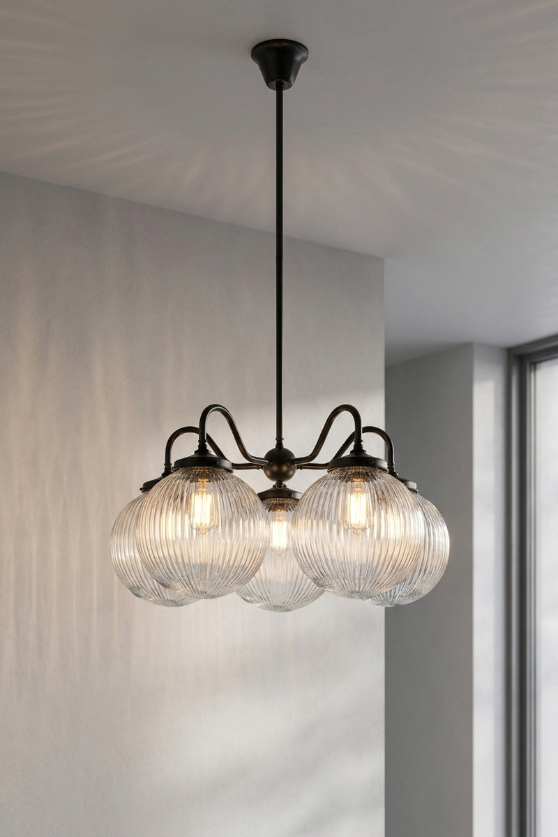 5 arm chandelier with gooseneck style arms in black with medium clear reeded glass ball shades. 
