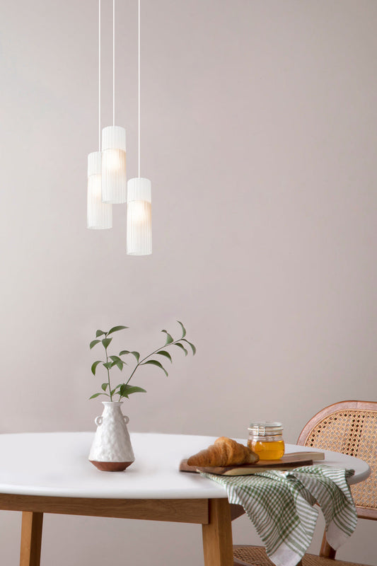 3 drop white pendant lights over dining table