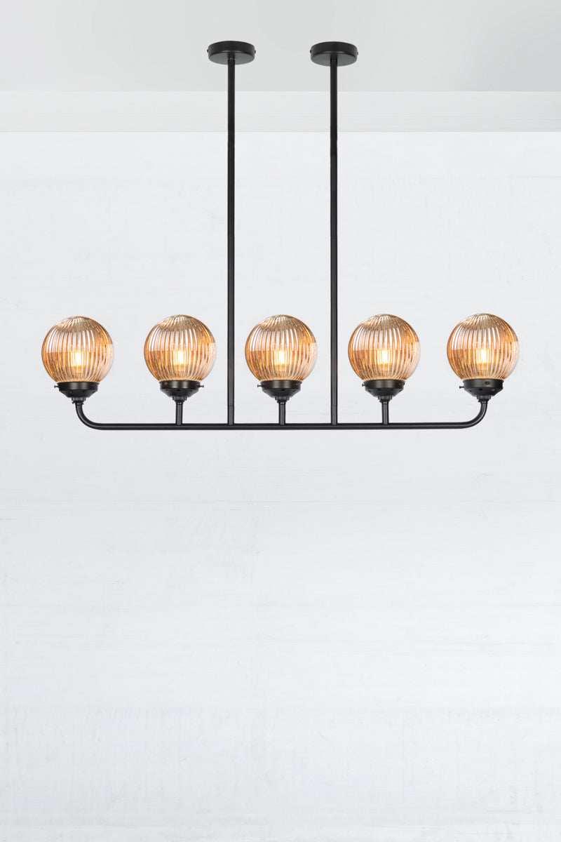 Black five light linear chandelier with dark amber reeded glass ball shades. 