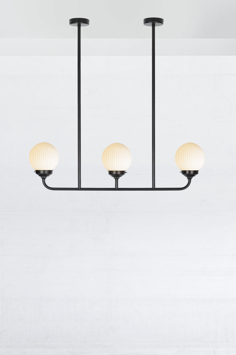 Gold/Brass five lamp linear chandelier with opal reeded glass ball shades. 