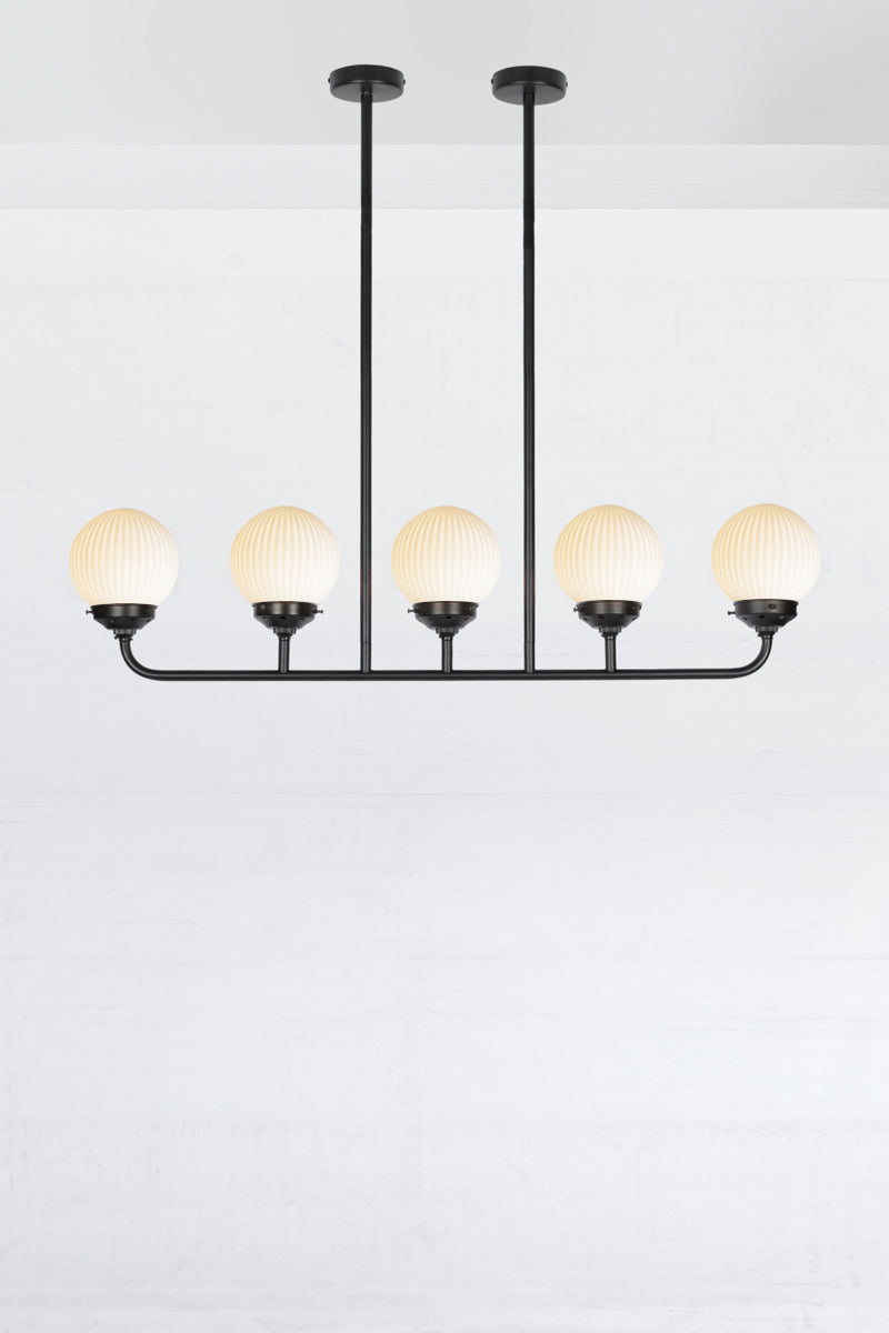 Black five lamp linear chandelier with opal reeded glass ball shades. 