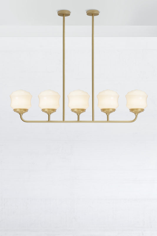 Five lamp gold/brass linear chandelier with schoolhouse style flinders opal shades. 