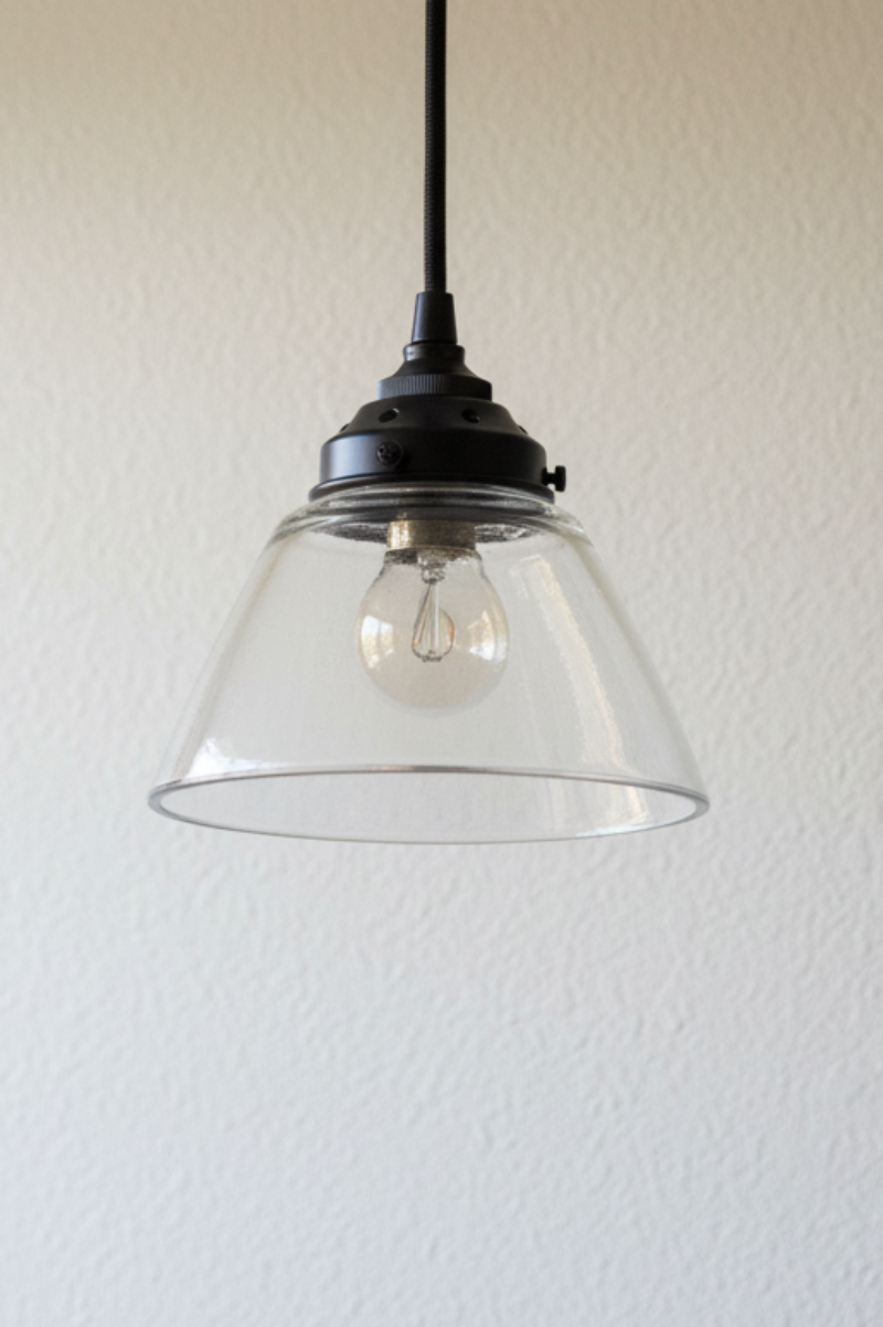 Clear glass open shade on a black pendant cord