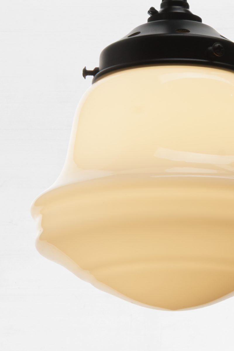 Close-up of illuminated Colton Schoolhouse Chandelier shade showing stepped schoolhouse glass profile