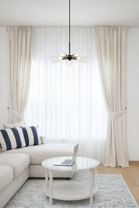 five light pendant light with white brass cage shades over coffee table in a living room