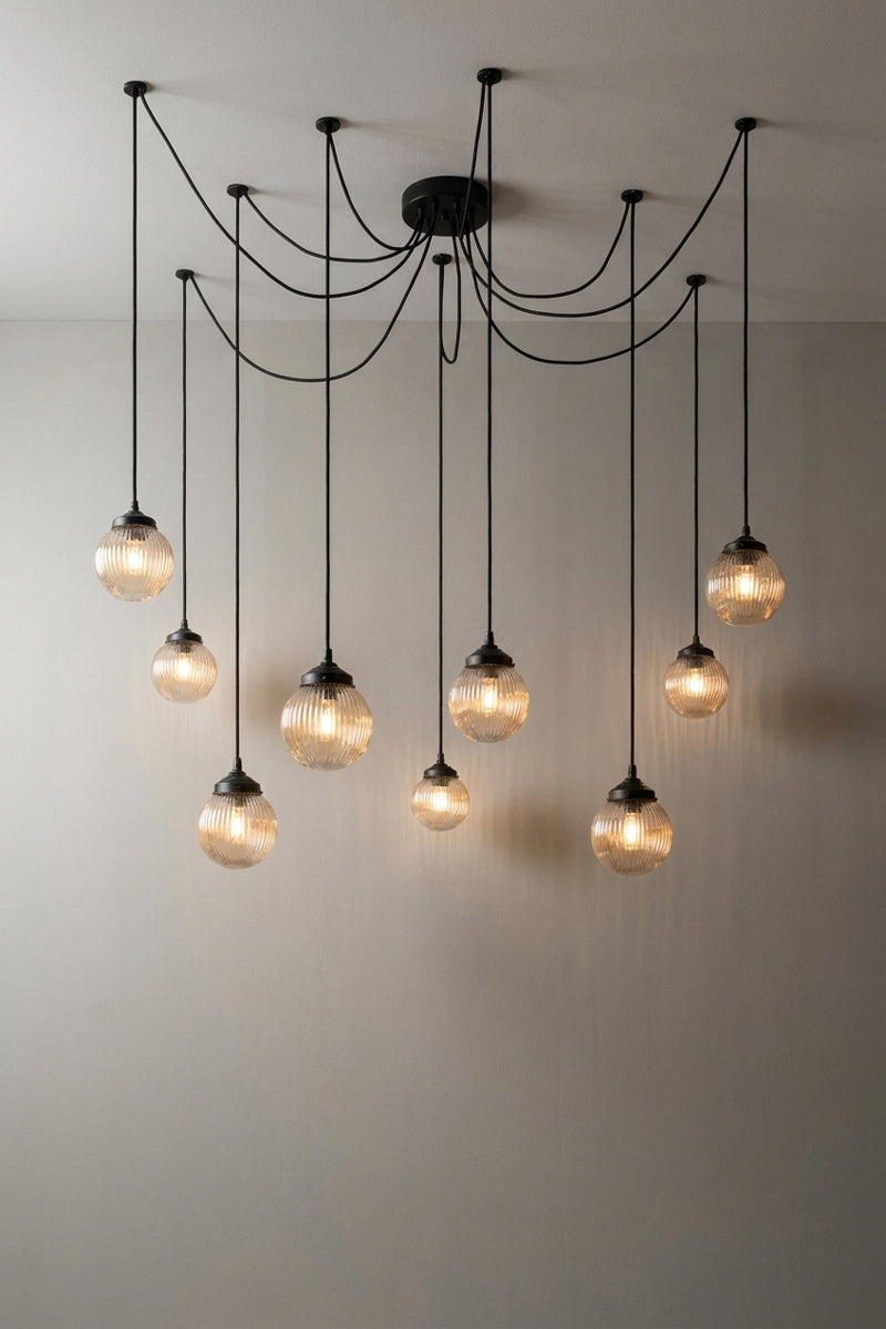 9 drop chandelier with mounting plates and dark amber reeded glass shades.