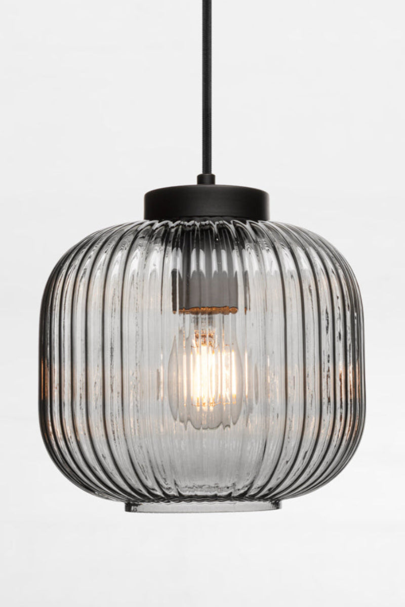 Glass pendant in grey featuring vertical ridges across its surface