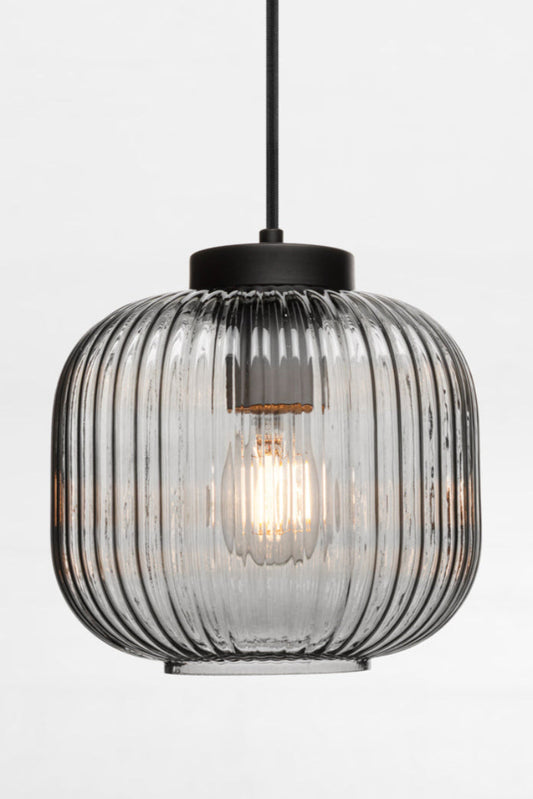 Glass pendant in grey featuring vertical ridges across its surface