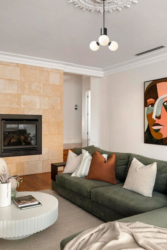 3 opal glass ball orb chandelier on a black fixture in a modern lounge room. 