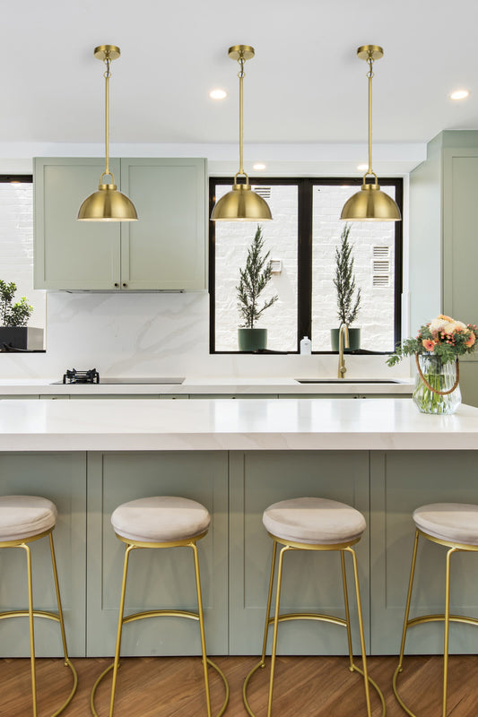 3 Antique Gold small dome shade pendant lights over a kitchen bench. 