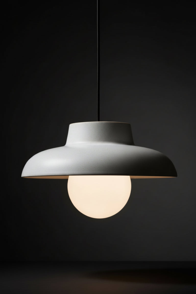 Ceramic light grey pendant light with opal glass ball shade and black fabric cord. 