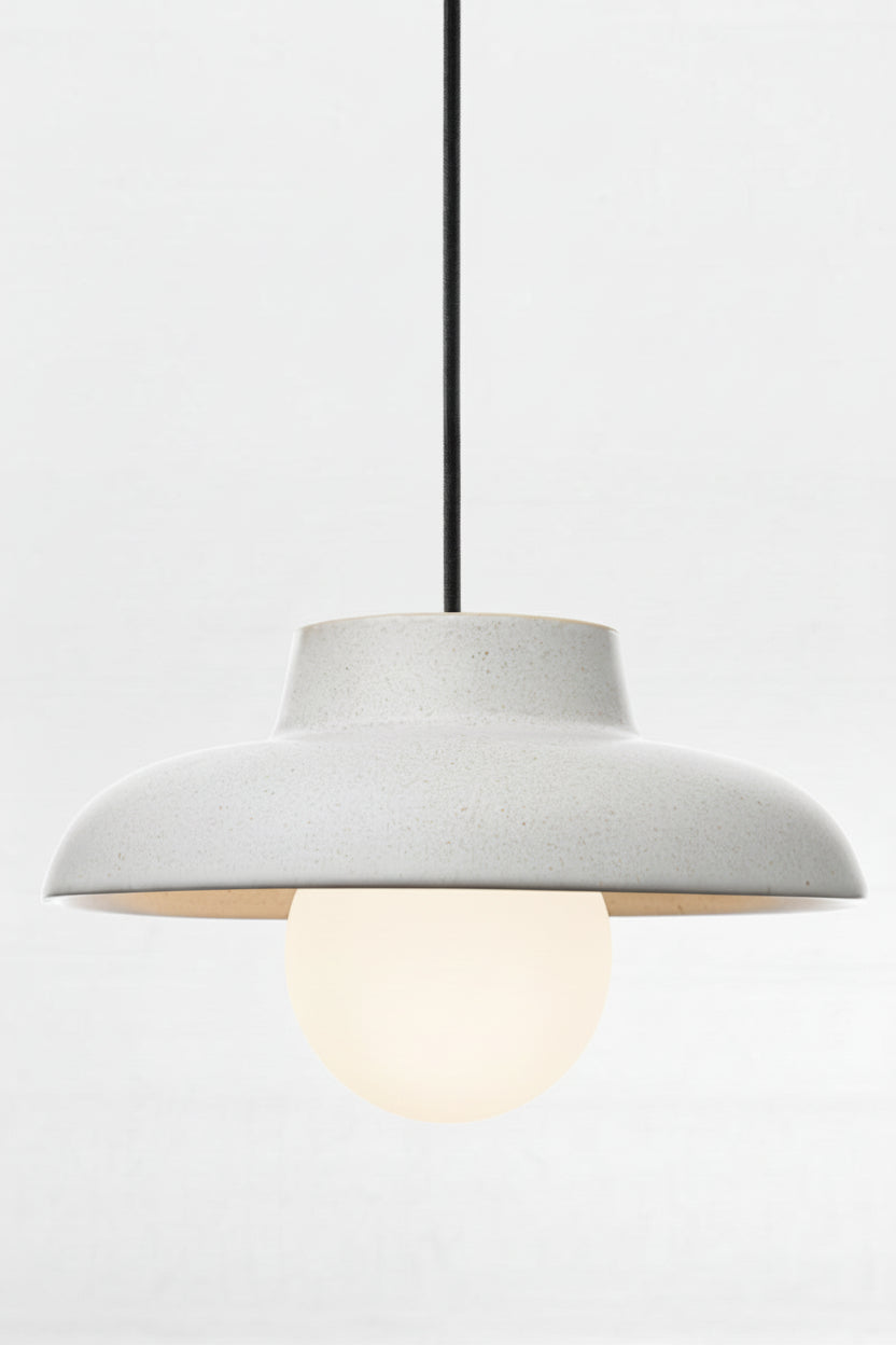 Ceramic light grey pendant light with opal glass ball shade and black fabric cord. 