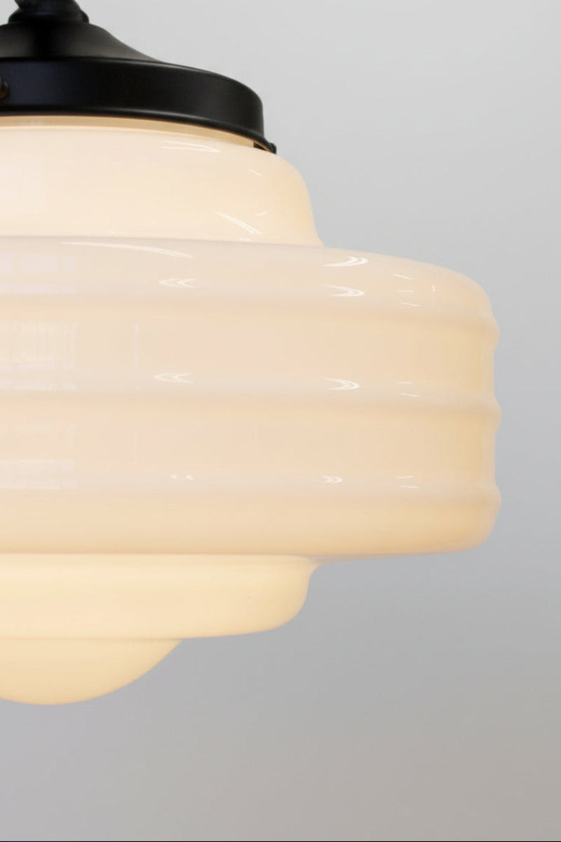 Close up of the large boston schoolhouse shade on a black gallery. 