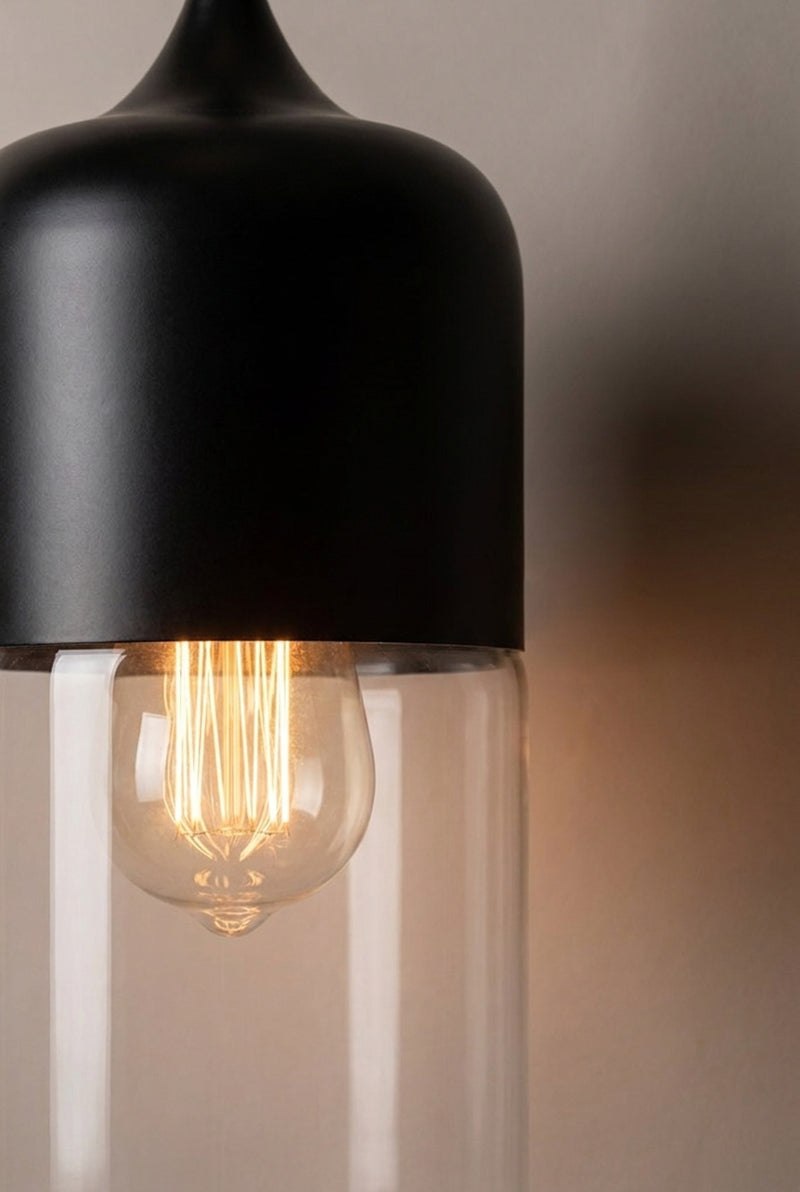 Close up of the Silhuette C of the Dalston industrial/ modern glass and metal pendant light. Paired with a clear bulb. 