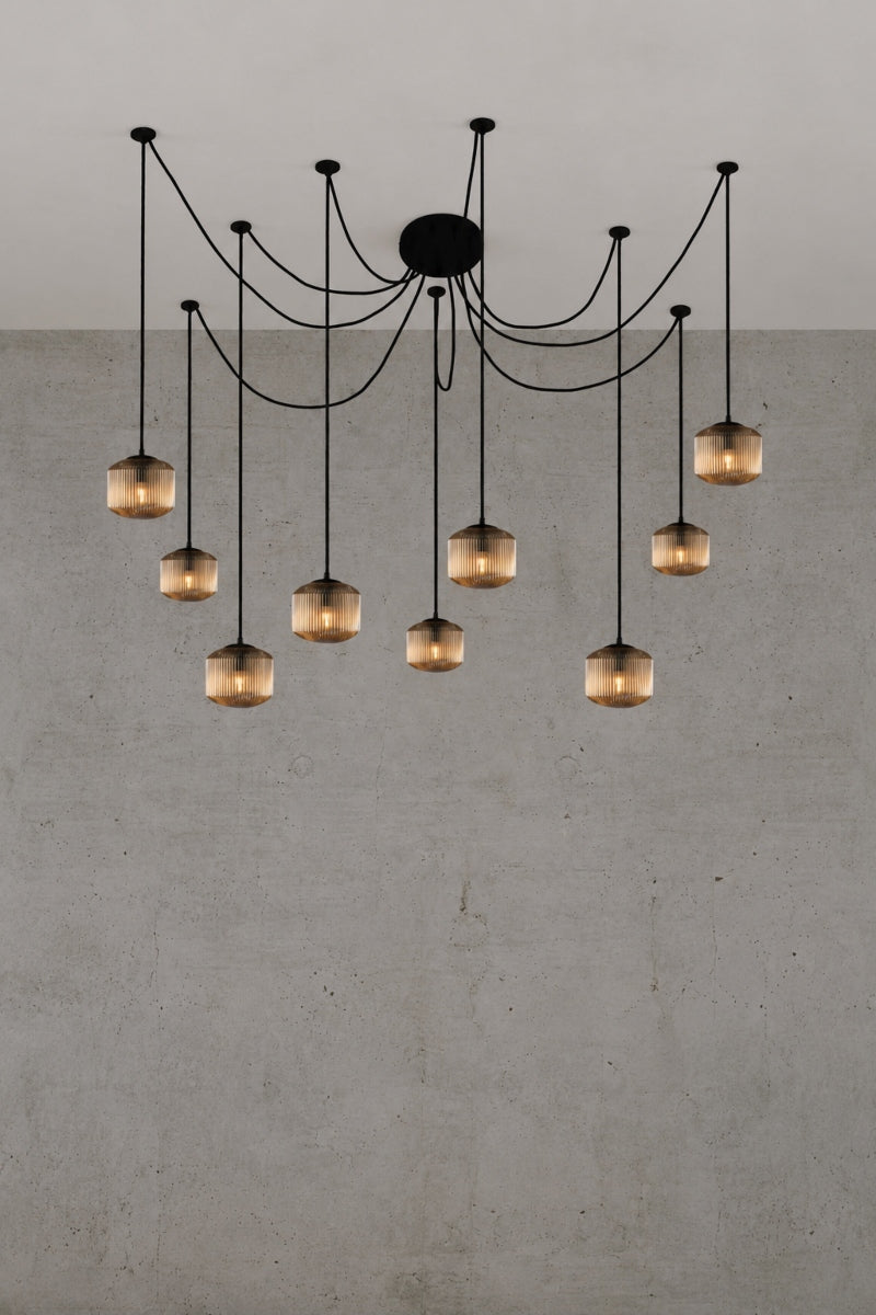 9 drop chanderlier with amber, reeded glass shades and black cord and hardware. 