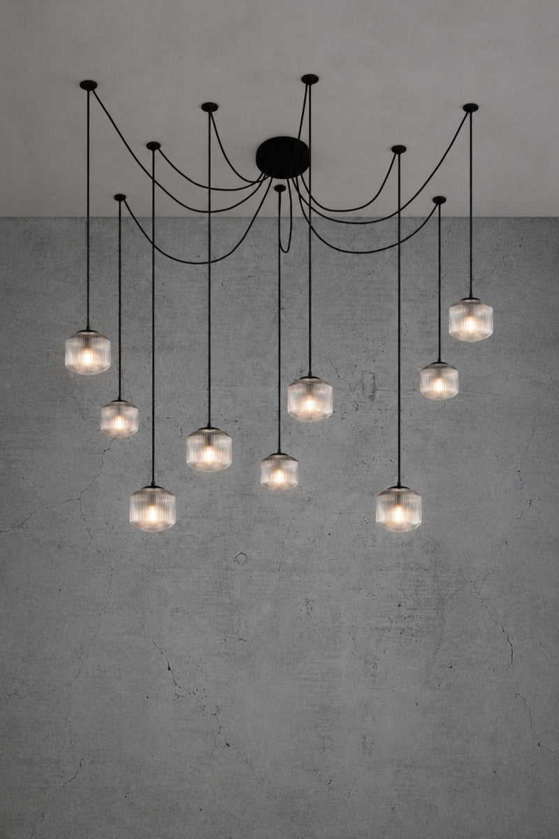 9 drop chanderlier with clear, reeded glass shades and black cord and hardware. 