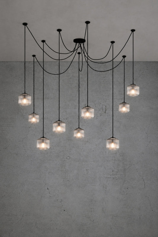 9 drop chanderlier with clear, reeded glass shades and black cord and hardware. 