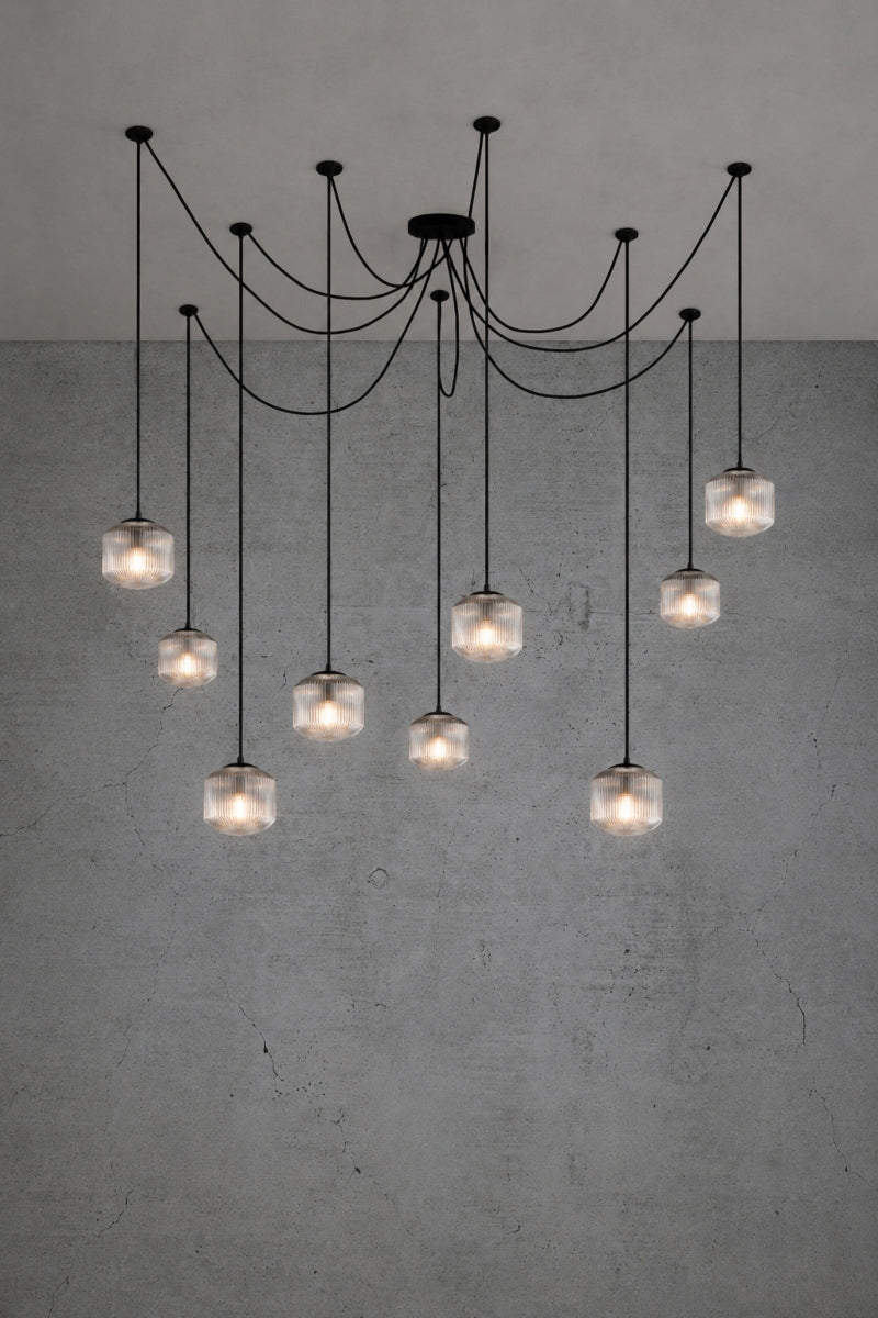 9 drop chanderlier with clear, reeded glass shades and black cord and hardware. 