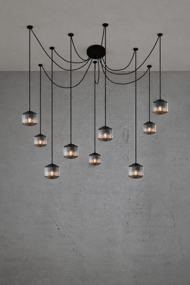 9 drop chanderlier with grey, reeded glass shades and black cord and hardware. 