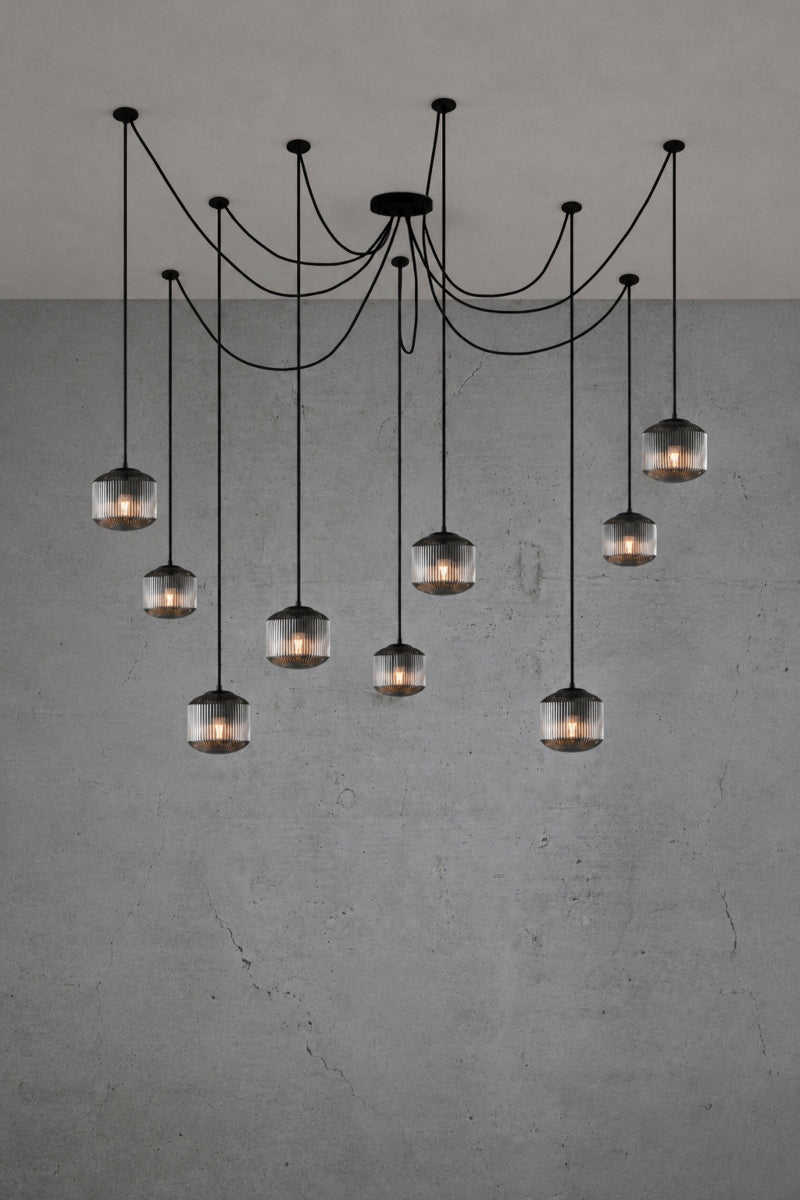 9 drop chanderlier with grey, reeded glass shades and black cord and hardware. 