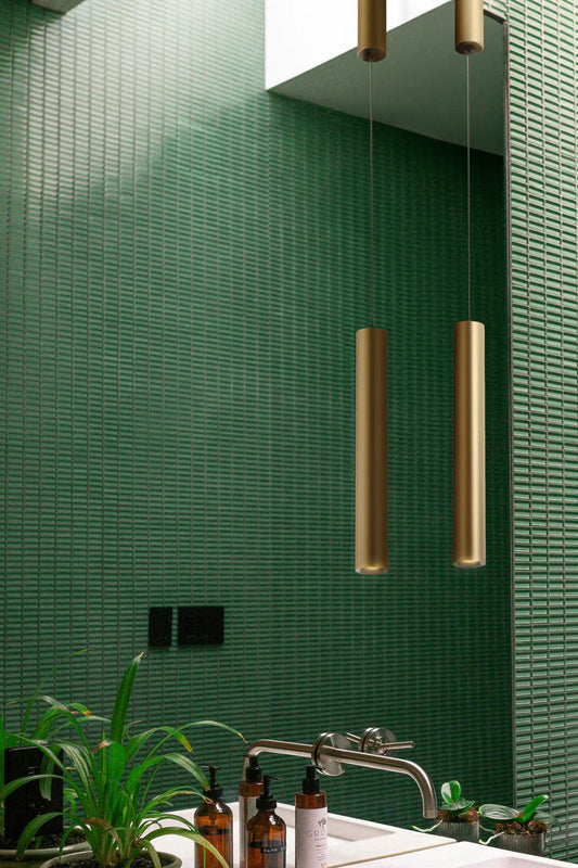 Brass coloured LED slimline pendant light in a green finger tiled bathroomg with natural light. 