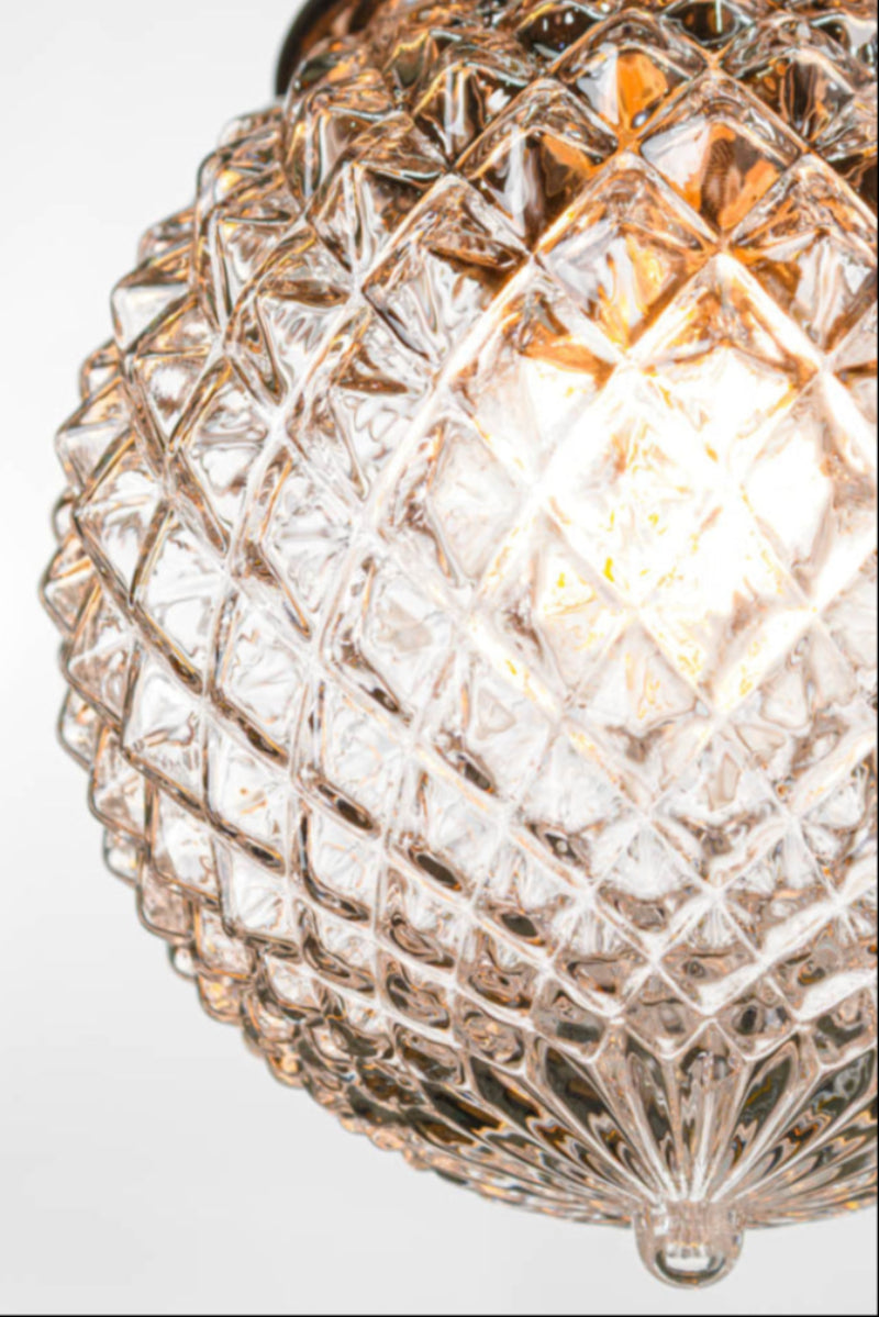 Decorative ceiling light fixture with clear glass shade on a black batten holder