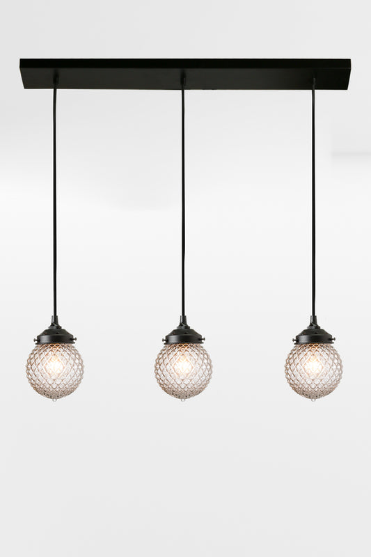 Three light linear with black hardware and vintage insipred textured glass. 