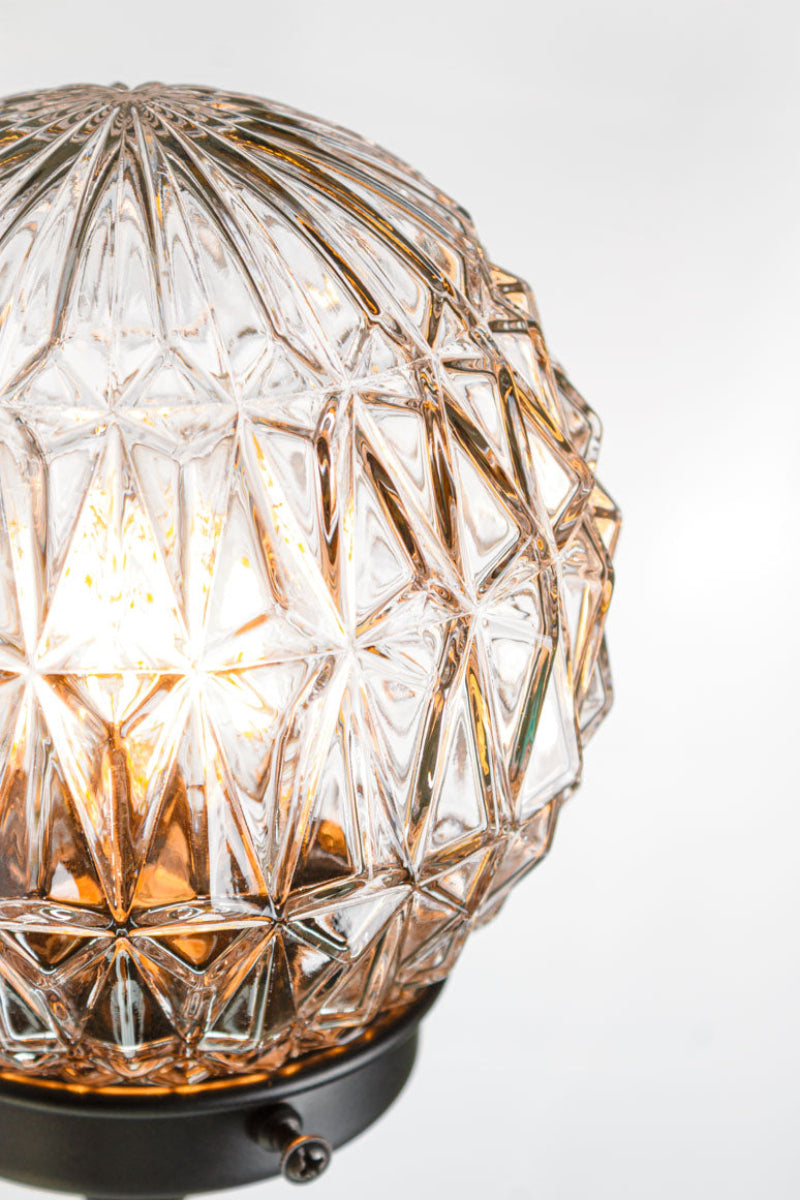 Close up of the diamond cut glass shade and black gallery. 