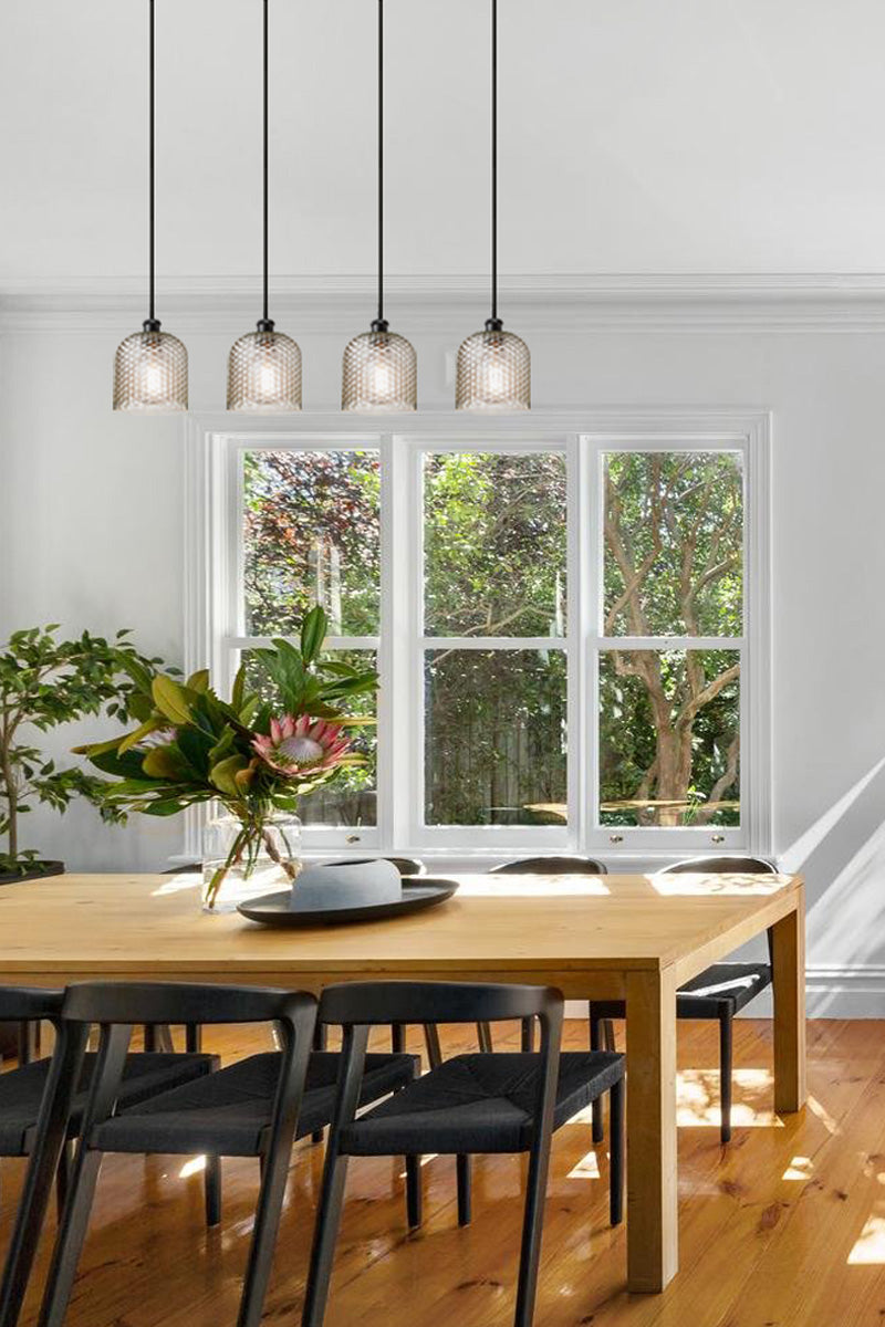four glass lights over dining table