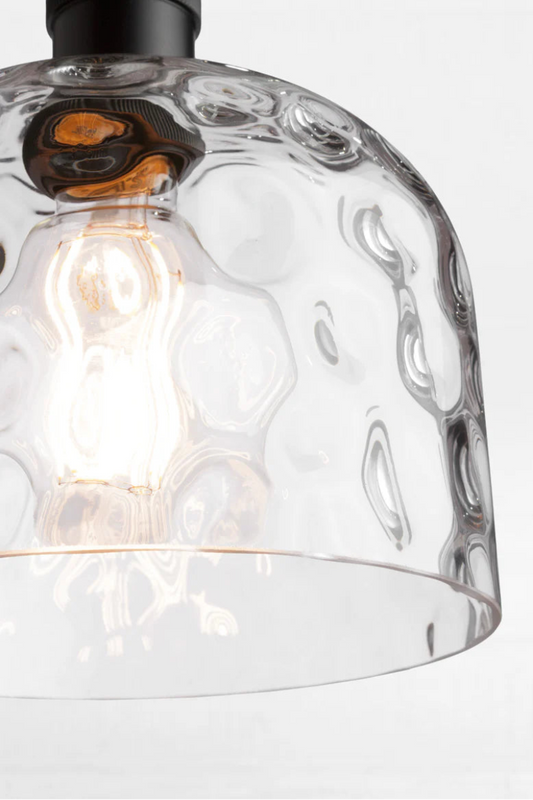 Textured clear glass scatters light with soft, organic distortion