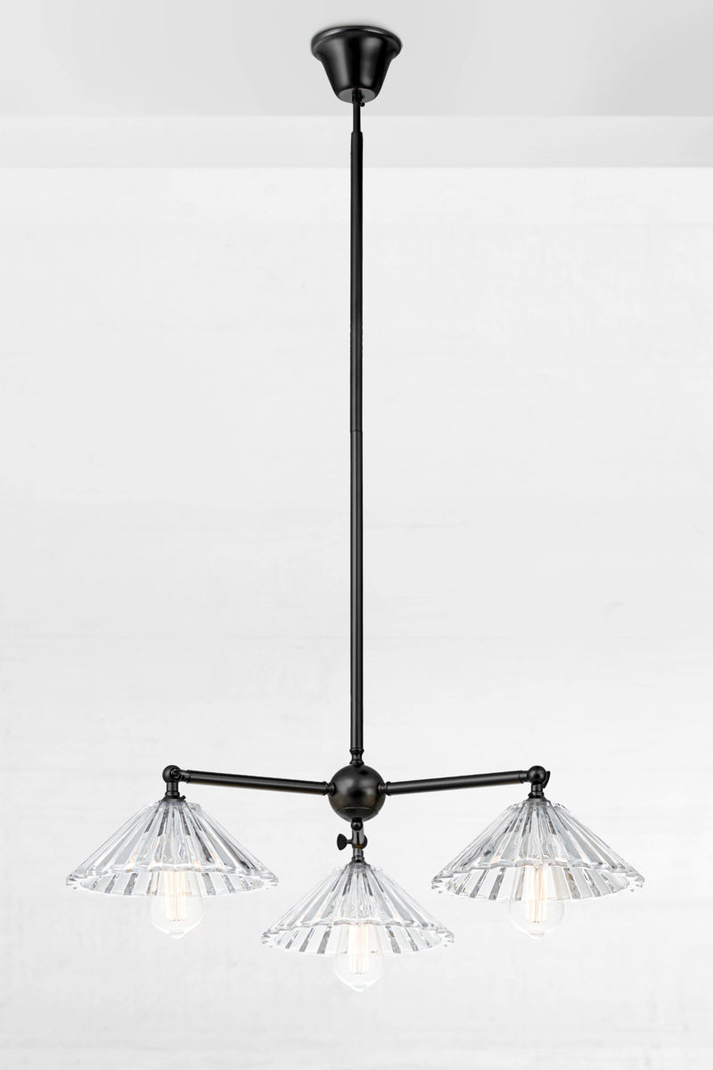 Black three light pendant with tiltable lampholders and three pleated glass shades. 
