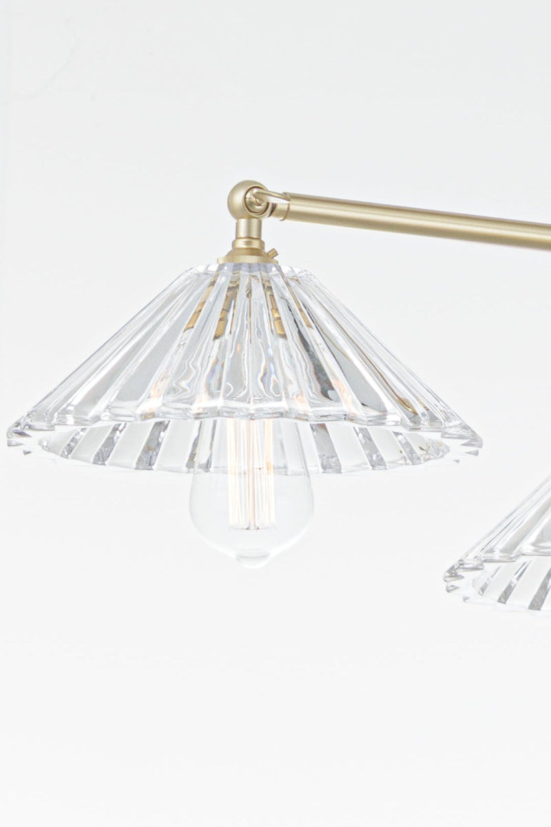 Close up of the gold arm and glass pleated shade. 