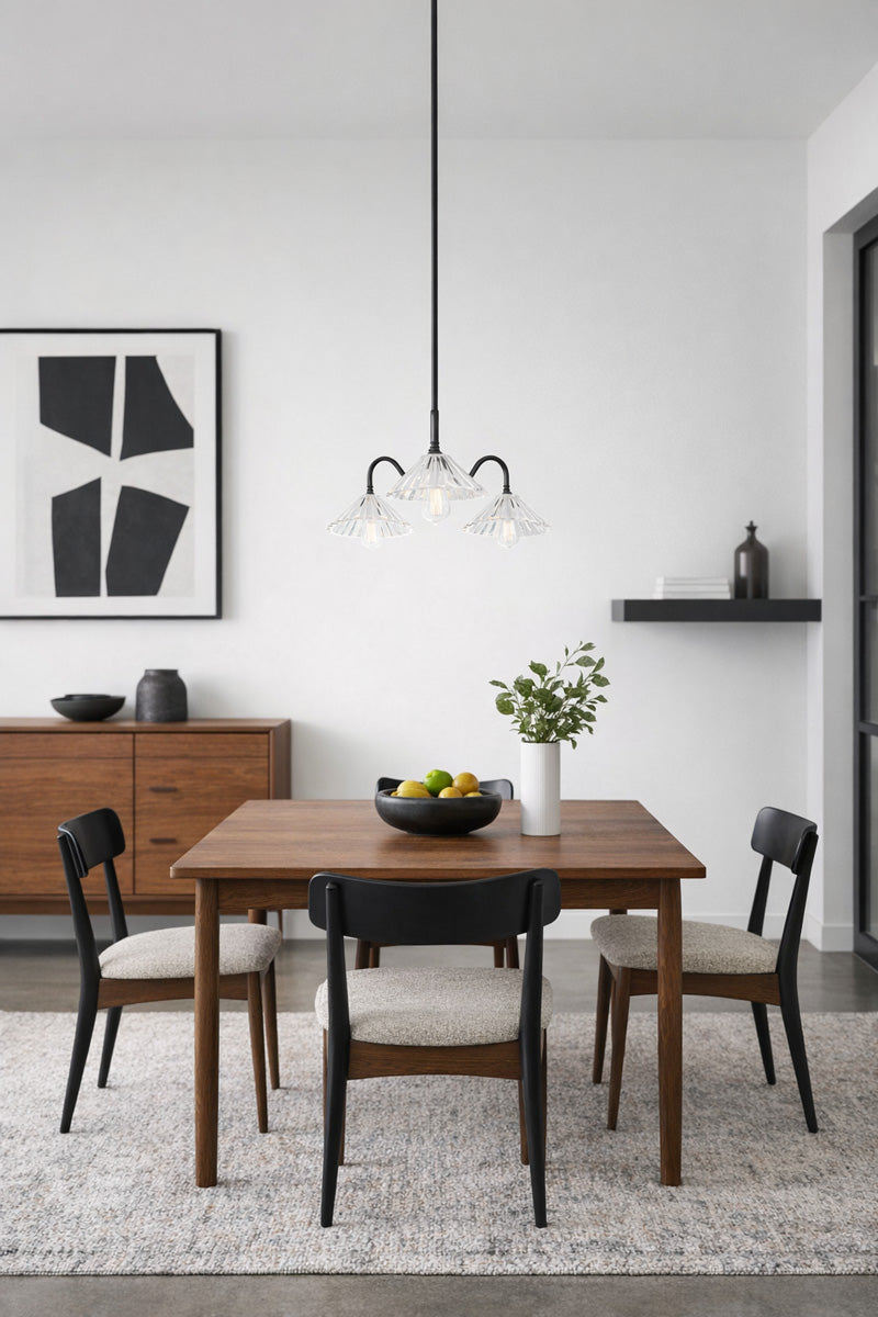 Black triple arm gooseneck chandelier with clear pleated glass shades in a mid century modern dining space. 