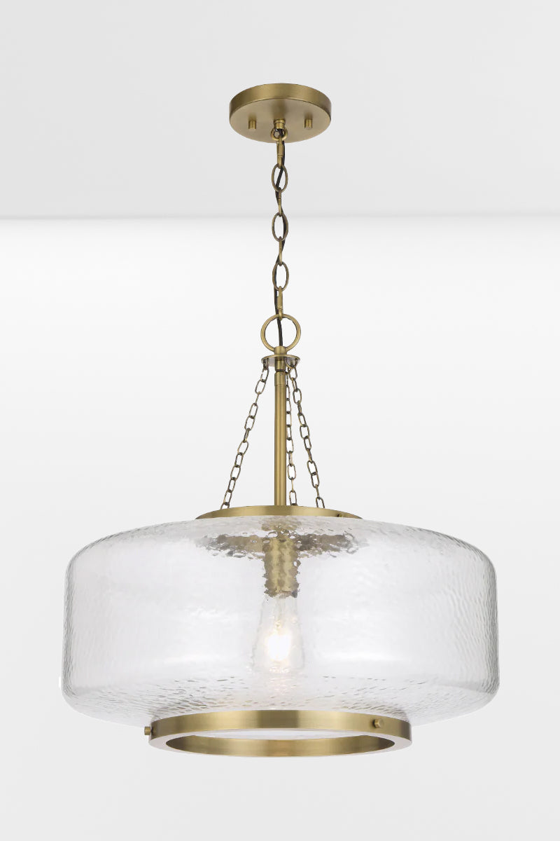 Gold/brass oval shade pendant light with textured glass. 