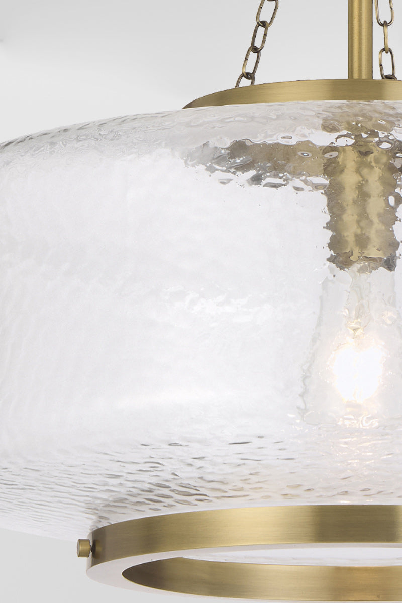 Gold/brass oval shade 's clear, textured glass.