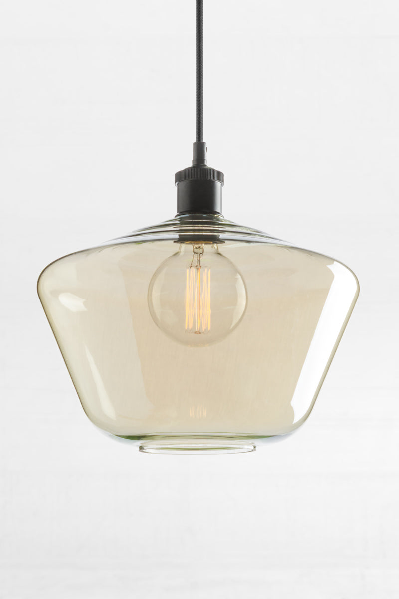Shade A- large schoolhouse shaped shade with champagne finishes glass with a rippled top and a black lampholder. 