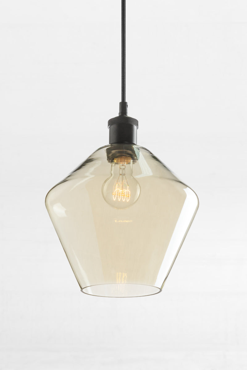Shade B- Medium almost diamond shaped shade with champagne finishes glass , opened end and a black lampholder.  
