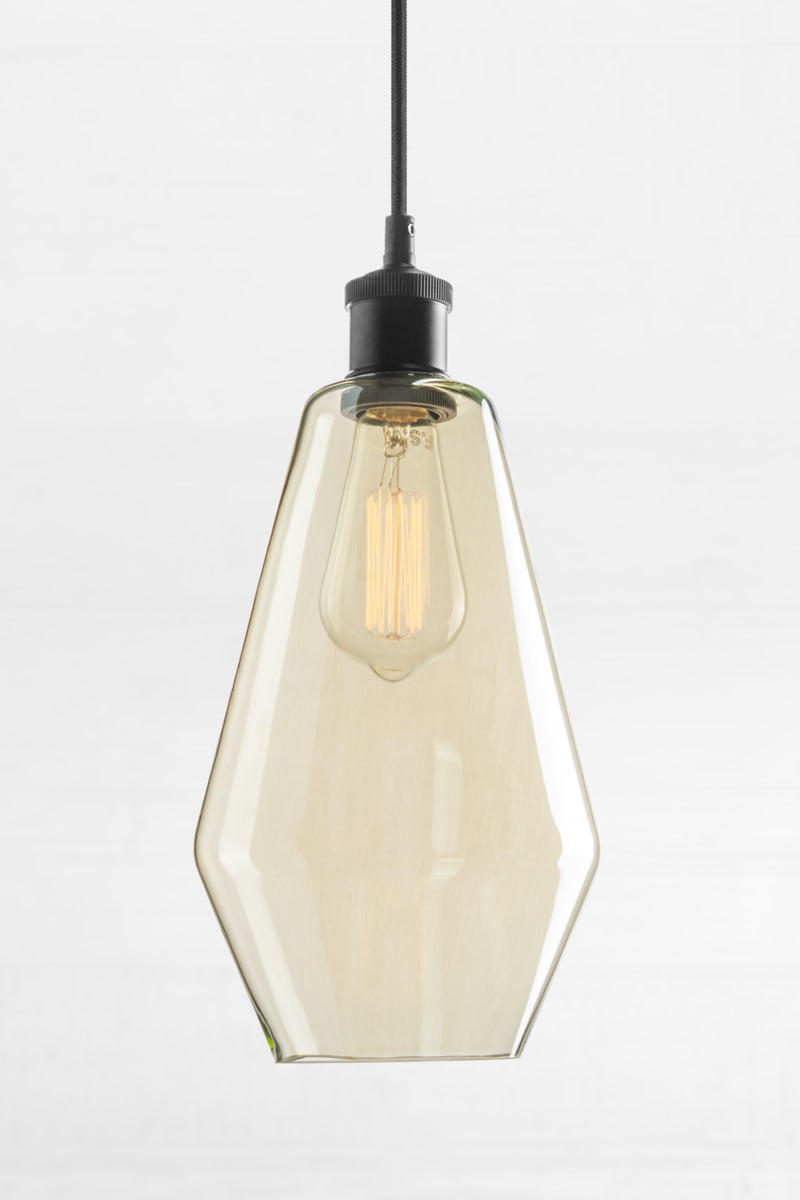 Shade C- Cylindrical shaped shade with champagne finish glass and a black lampholder.  