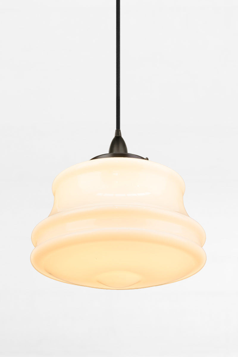 Classic opal glass light shade paired with a black pendant cord for versatile styling. 